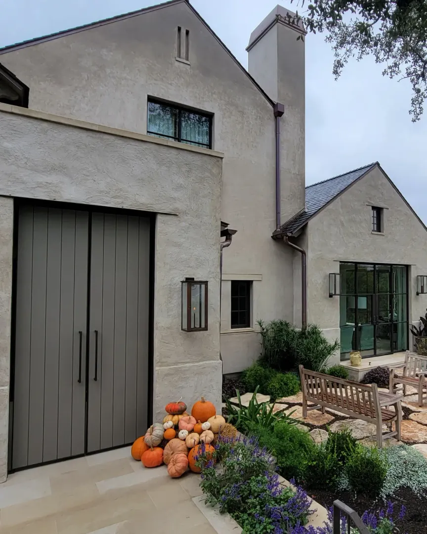 Finished Park Hills entry courtyard with a tall custom paneled door and landscaped terrace.