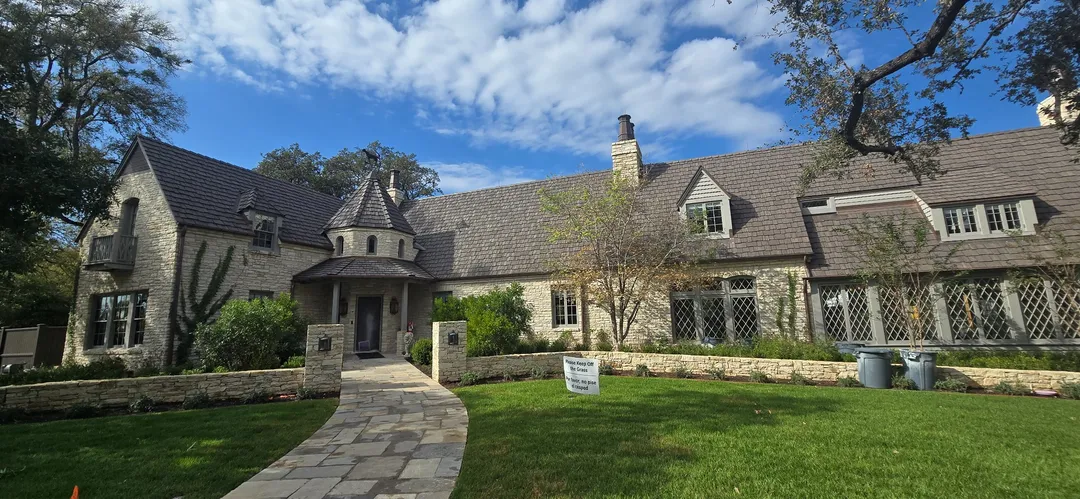 Completed stone residence and landscaped front approach at Tarry Trl.