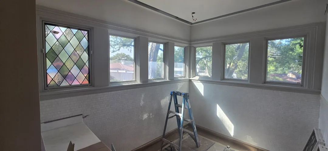 Finished room with diamond-pane accent windows and painted trim.