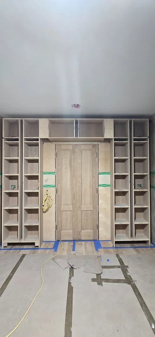 Built-in shelving and centered paneled doors during installation.